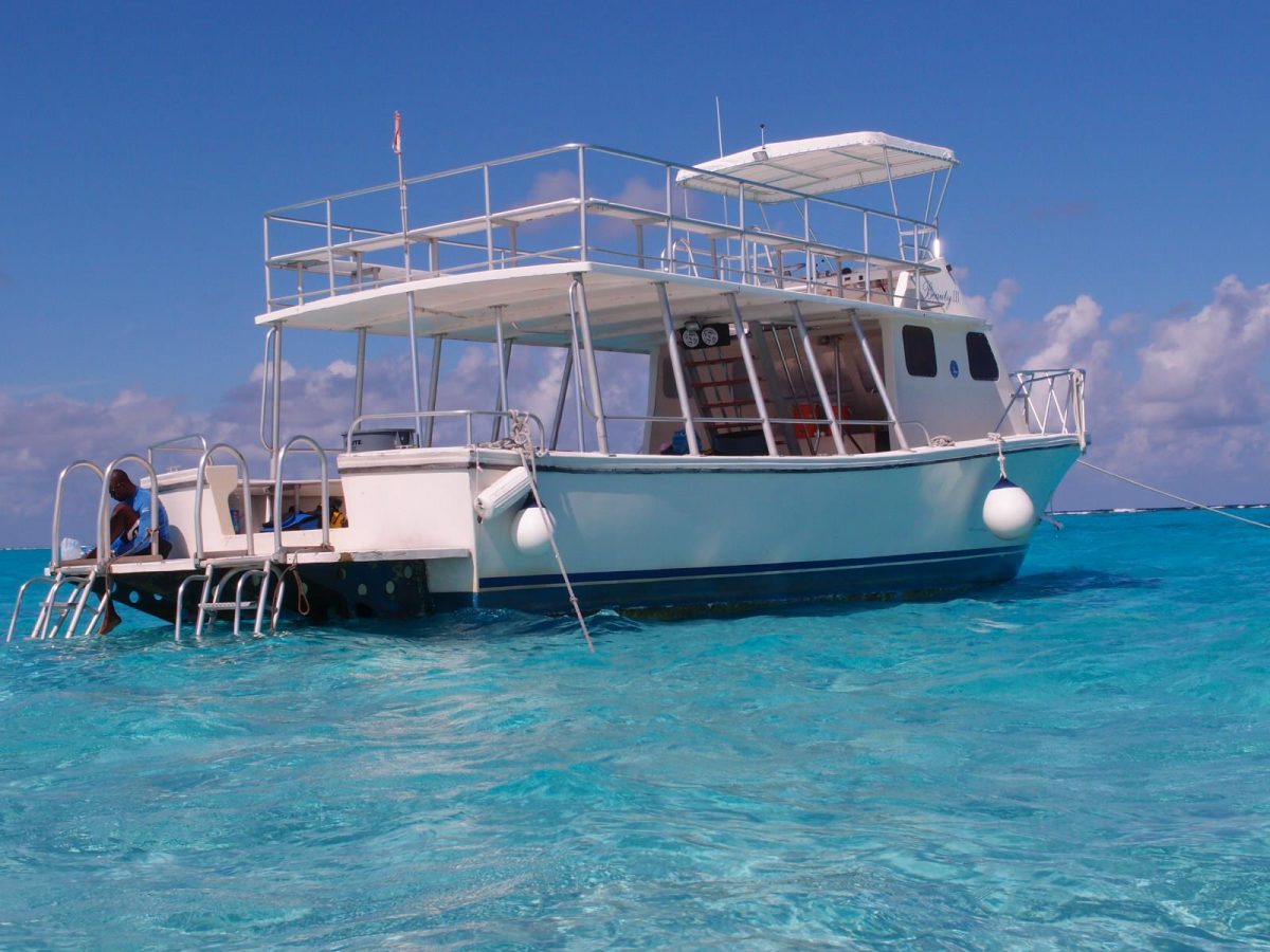 Tours Cayman private charter boat Destiny III on turquoise Grand Cayman waters, ready for a Stingray City tour